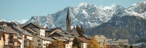 brown and white houses near mountains during daytime