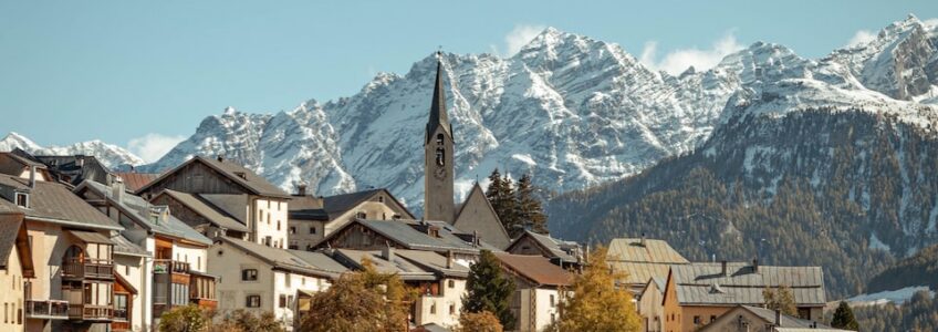 brown and white houses near mountains during daytime